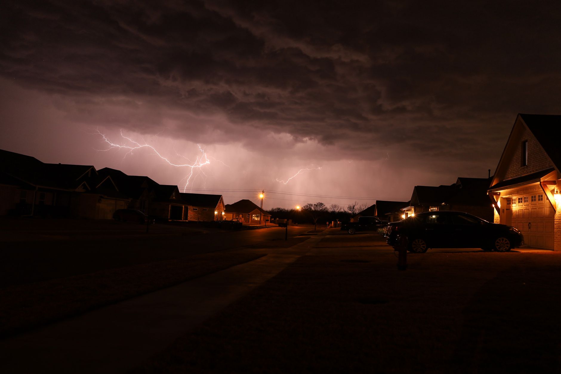 Severe thunderstorm with lightning over a residential neighborhood